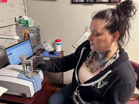 Bobbie Lee operating the FTIR machine to check drug composition